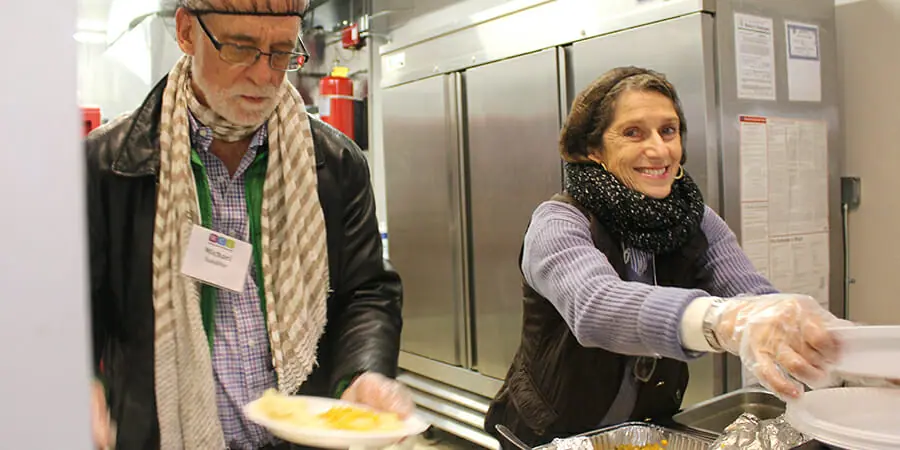 Michael Sandifer and Pucci McGill help to serve a meal at Greater Waterbury Interfaith Ministries during the WCL human services session. Investing in Leaders